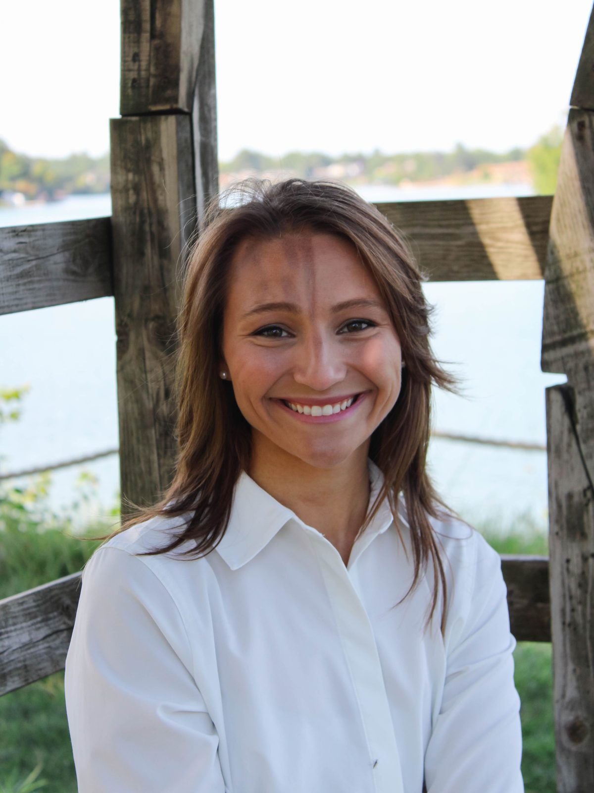 Dr. Abby Maidlow smiling, with Belleville Lake behind her.