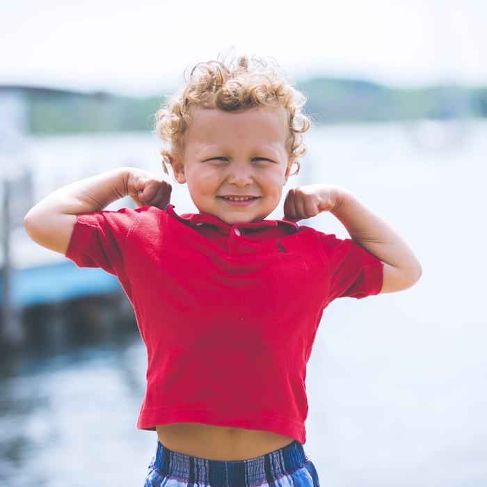 A child playing at the edge of the water.
